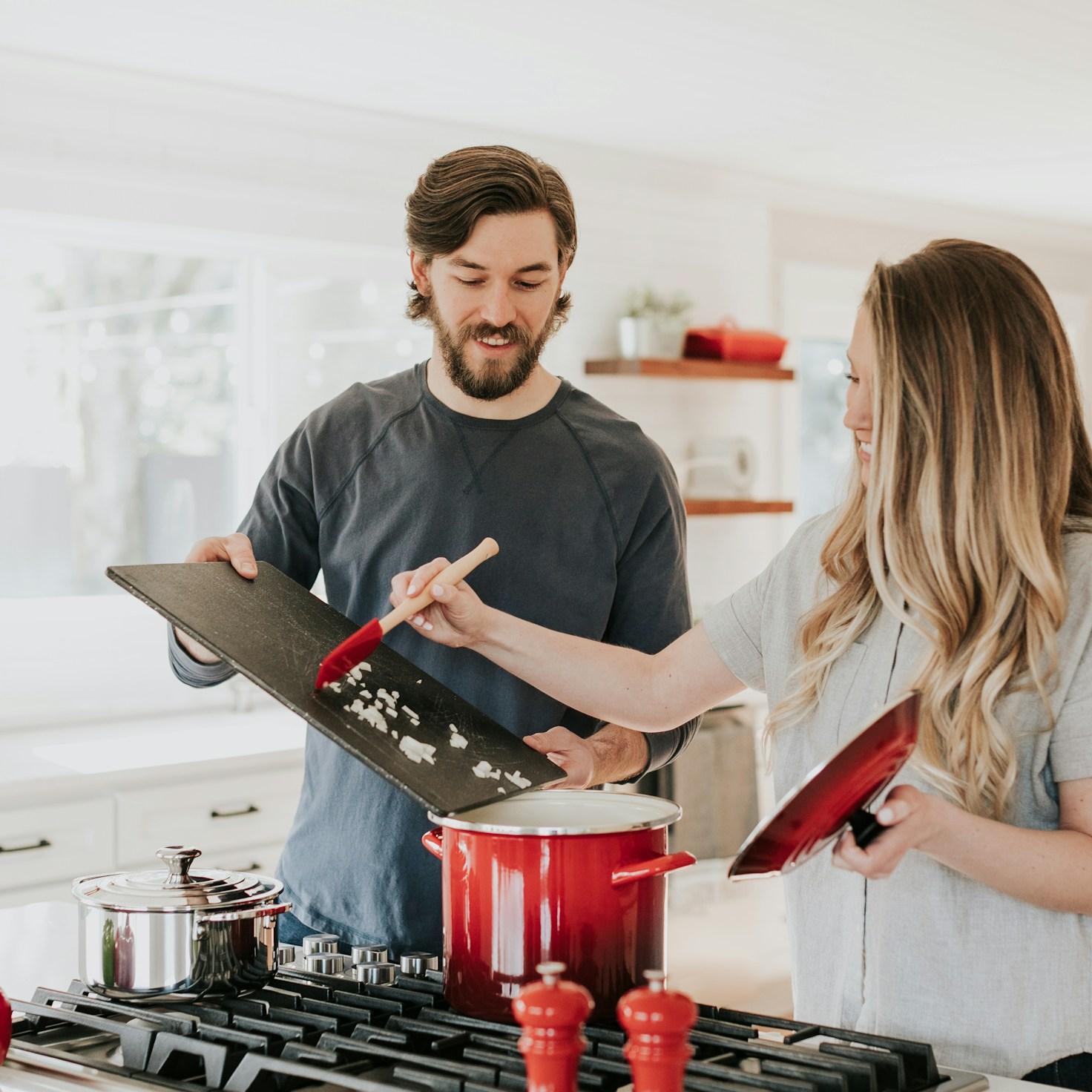 Community members collaborating in a modern kitchen space, sharing recipes and cooking techniques